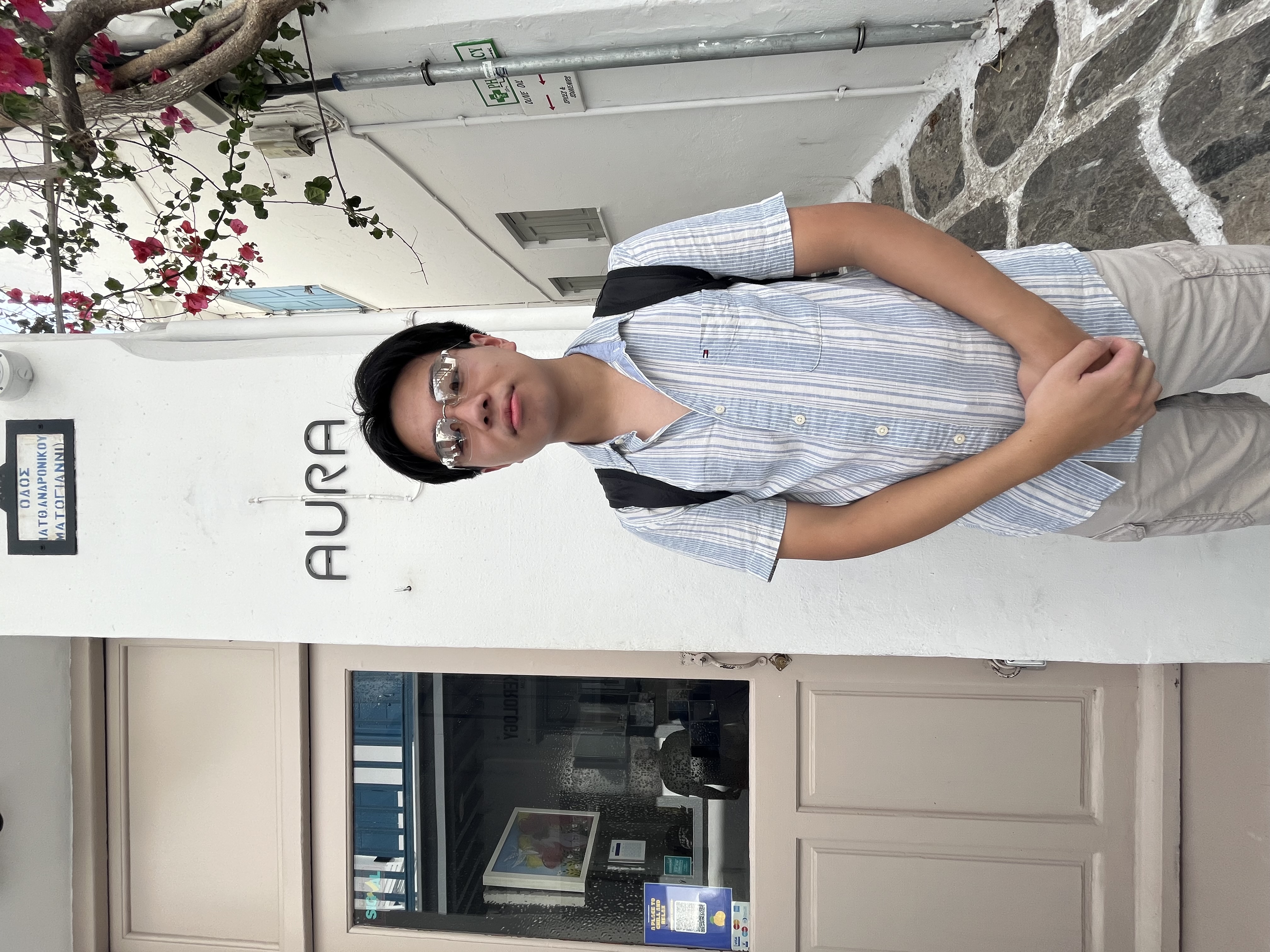 Ryan Chan standing next to sign that says AURA